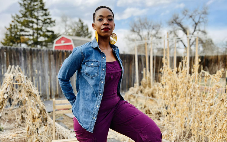 Woman posing in purple overalls